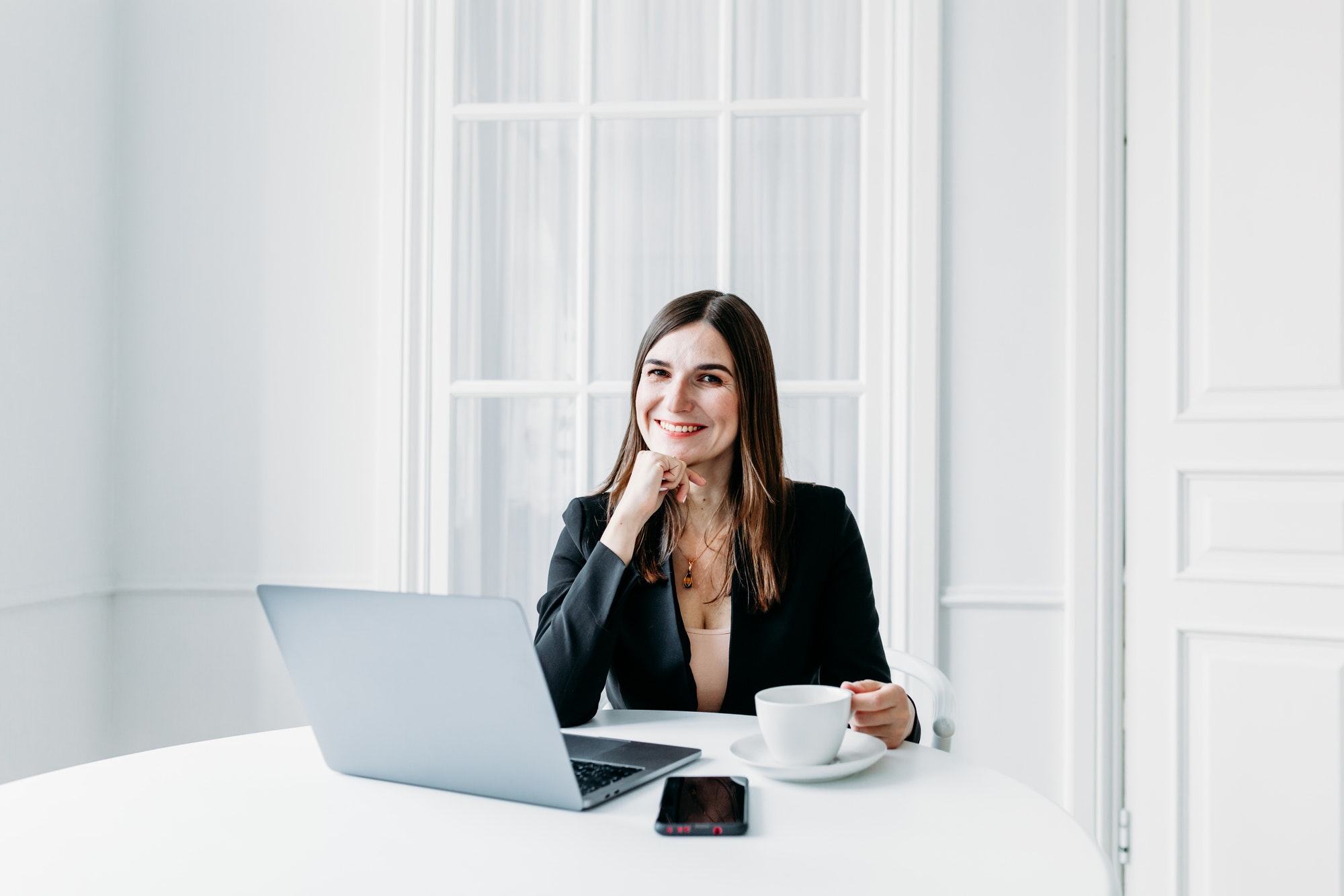 Girl in dark clothes, suit working on a laptop, lawyer, consultant, specialist, work in the office a