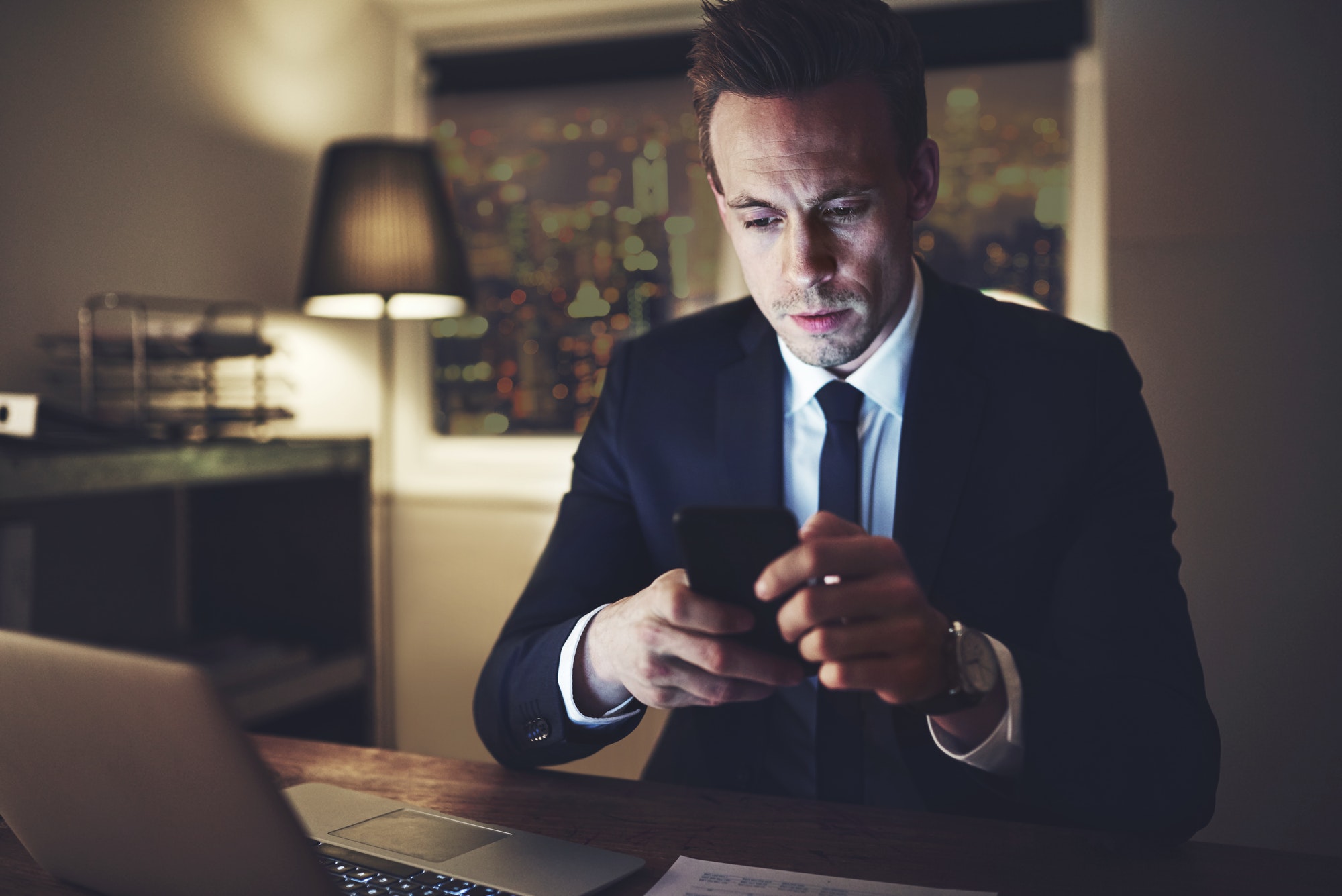 The accountant in the office surfing smartphone